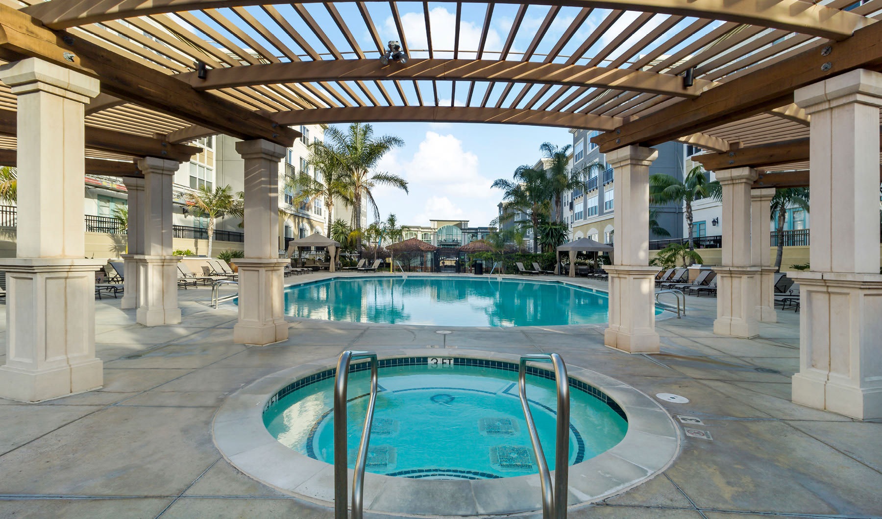 Relax and unwind poolside pool and hot tub under pergola